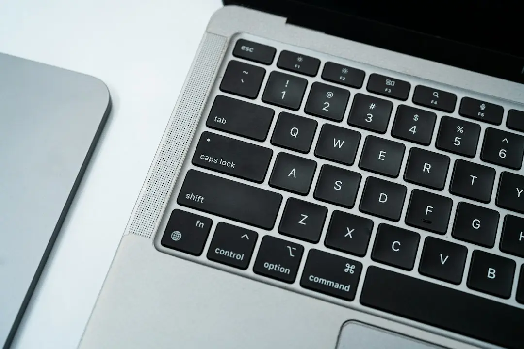 Close-up of a laptop keyboard on a white desk, where a Sapphire IPTV M3U playlist link gets copied and pasted